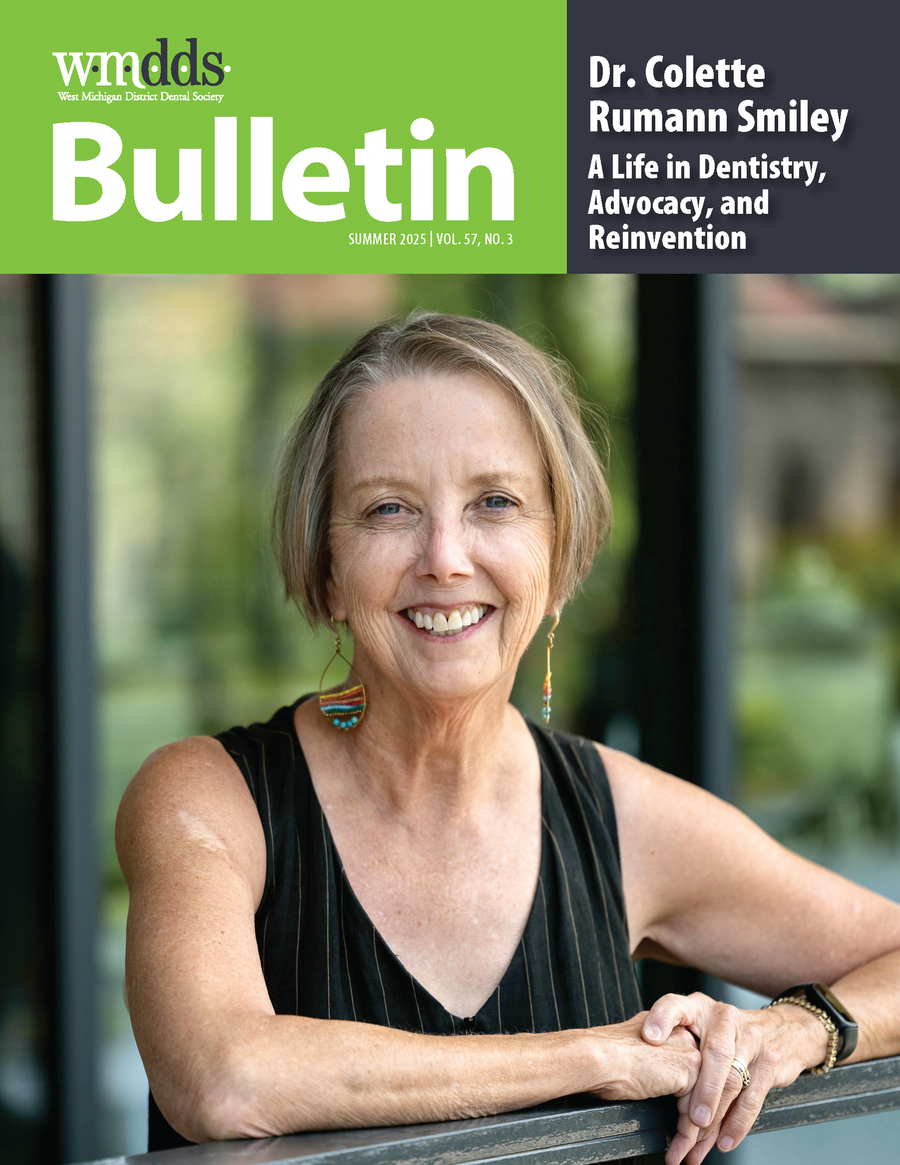 Dr. Rumann Smiley smiles for a photo outside. She is wearing casual clothes and artsy earrings.