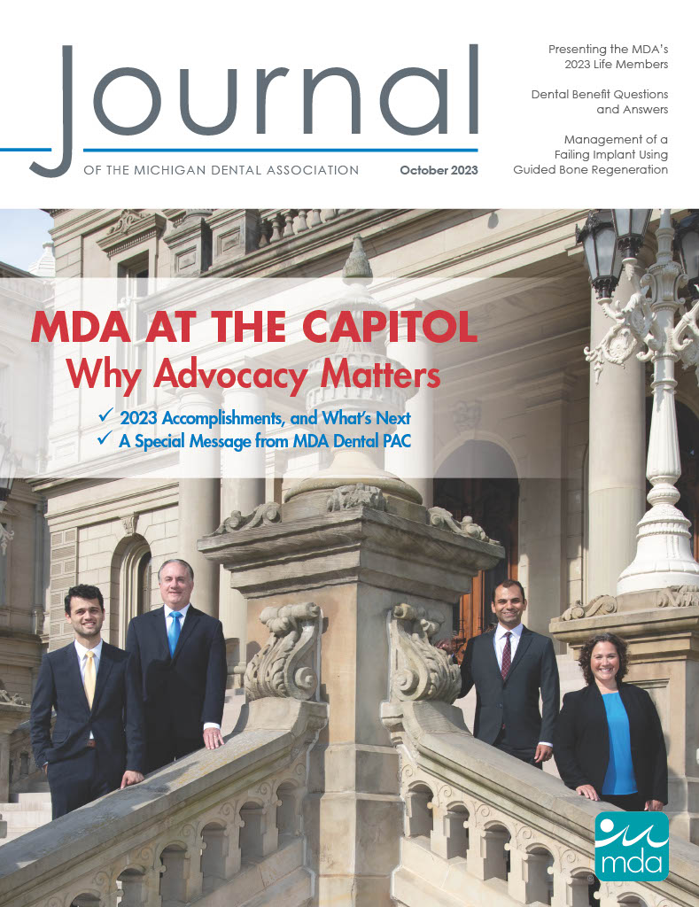 On the cover of the October 2023 Journal of the Michigan Dental Association four people stand on the steps of the Michigan state capitol building