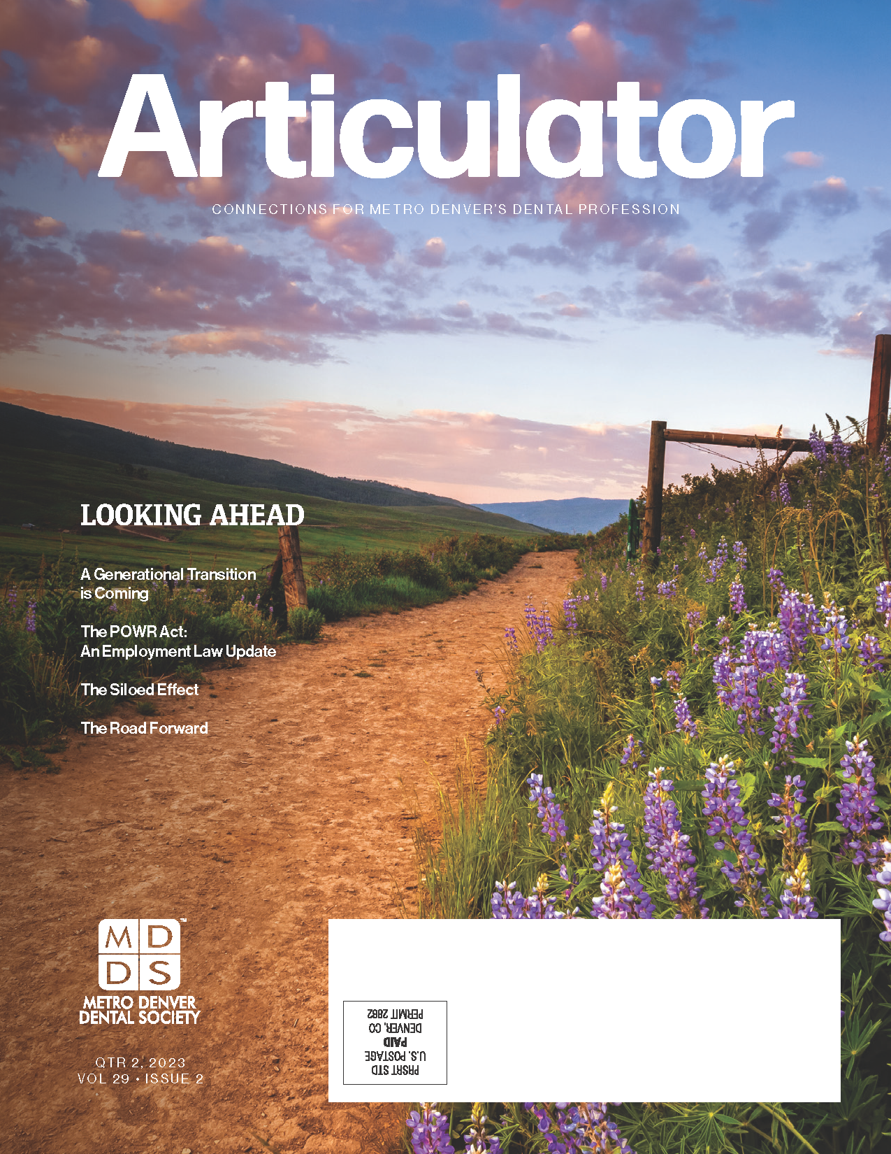 Cover of the Metro Denver Dental Society's Articulator magazine with image of a dirt trail leading through a grassy and hilly valley with purple flowers and an old fence.