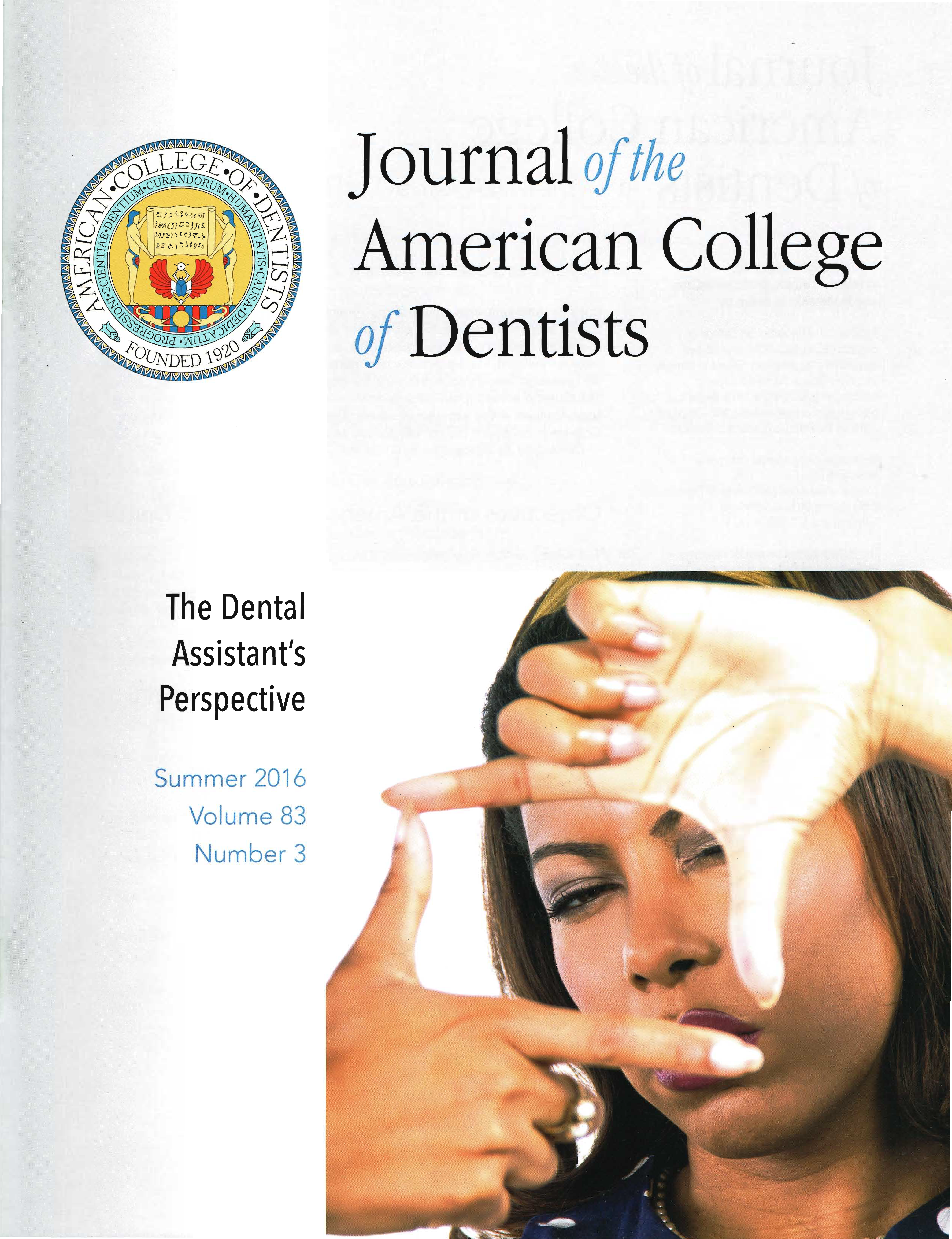 A person holds their fingers in a rectangle shape and looks through it into the camera