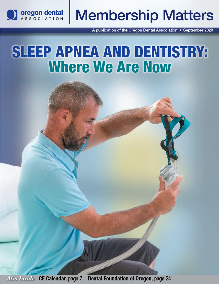 Photo of a person holding a sleep apnea or CPAP mask