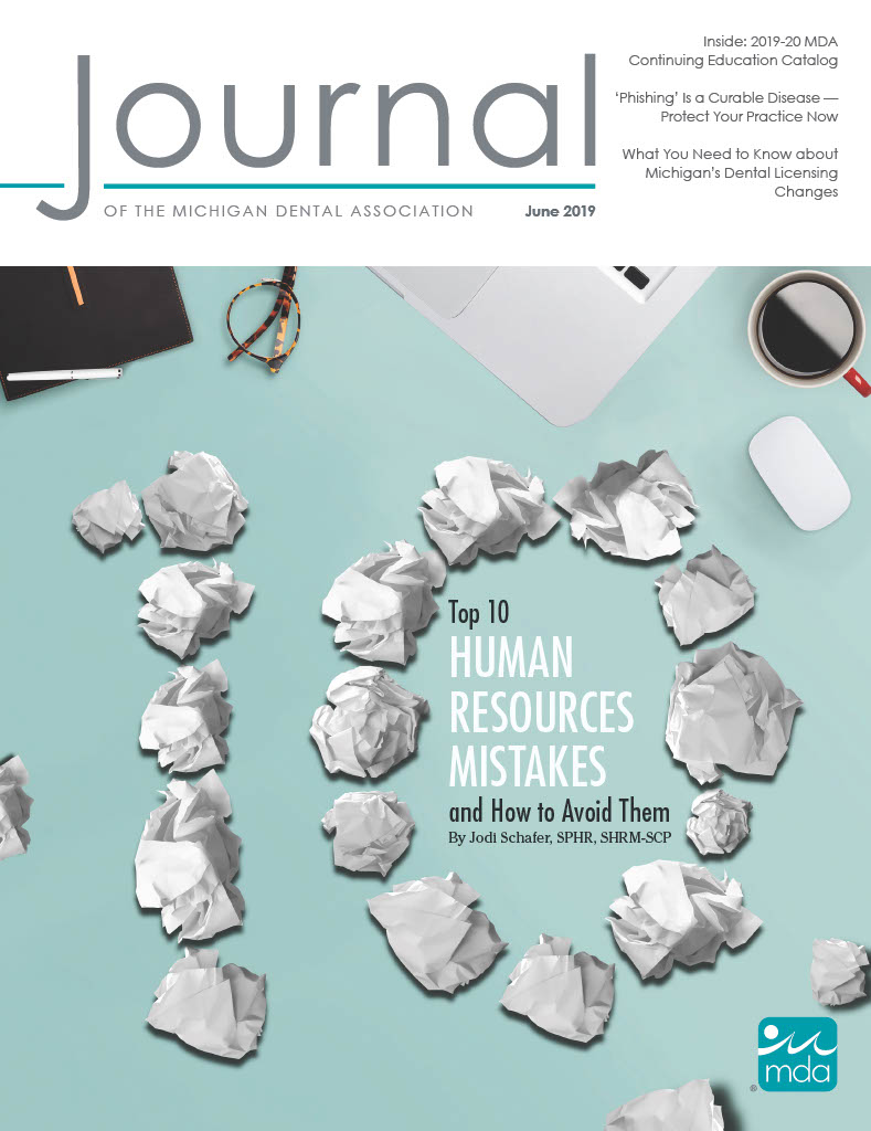Cover of the Journal of the Michigan Dental Association with crumpled papers making number 10. Typical desk clutter surrounds it.