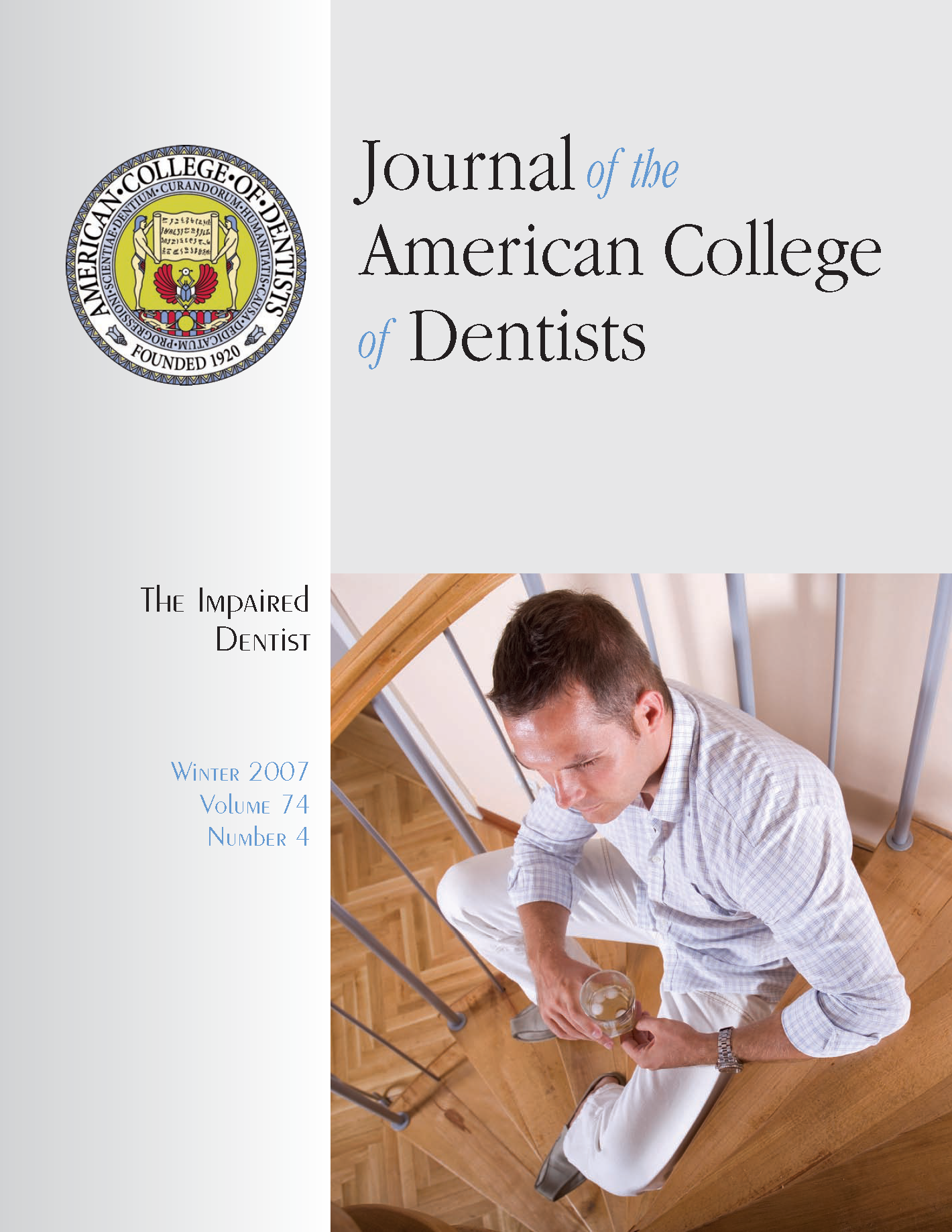 Photo of a professionally dressed man sitting at home with a glass of alcohol