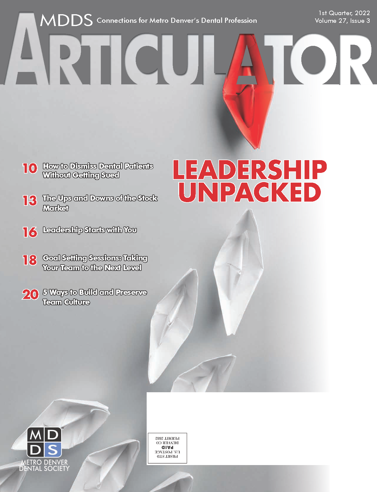 Cover of the Metro Denver Dental Society's Articulator magazine with image of white folded paper boats and a single red boat.