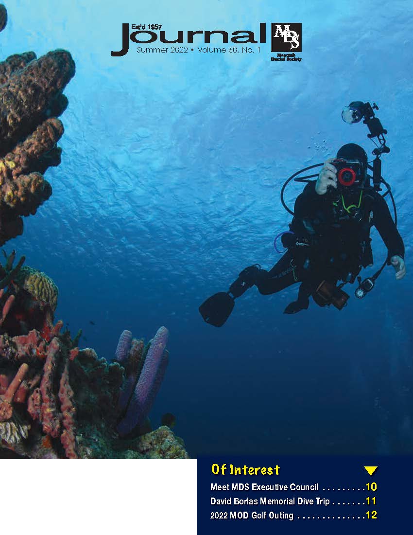 Photo of Jeff Baker scuba diving and taking photos of a reef in Bonaire during Macomb Dive Trip