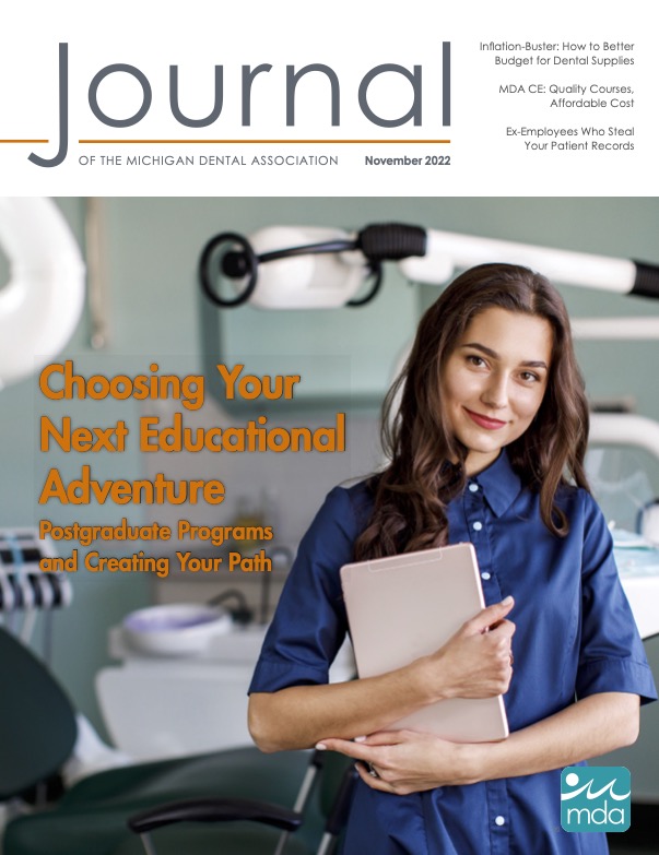 Cover of the Journal of the Michigan Dental Association with a professionally dressed person holding a tablet in a dental office, looking directly at the viewer.