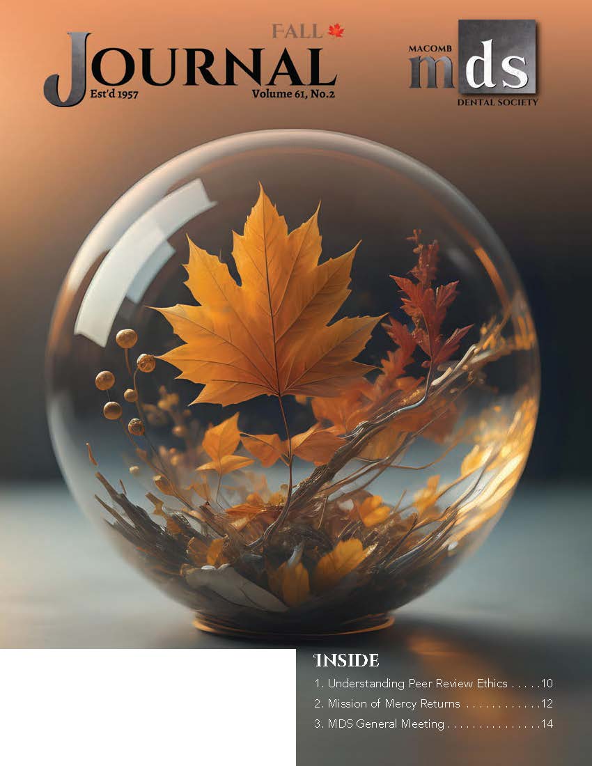 Cover of Journal of Macomb Dental Society featuring an autumn scene with an orange maple leaf and small twigs all enclosed in a glass ball.