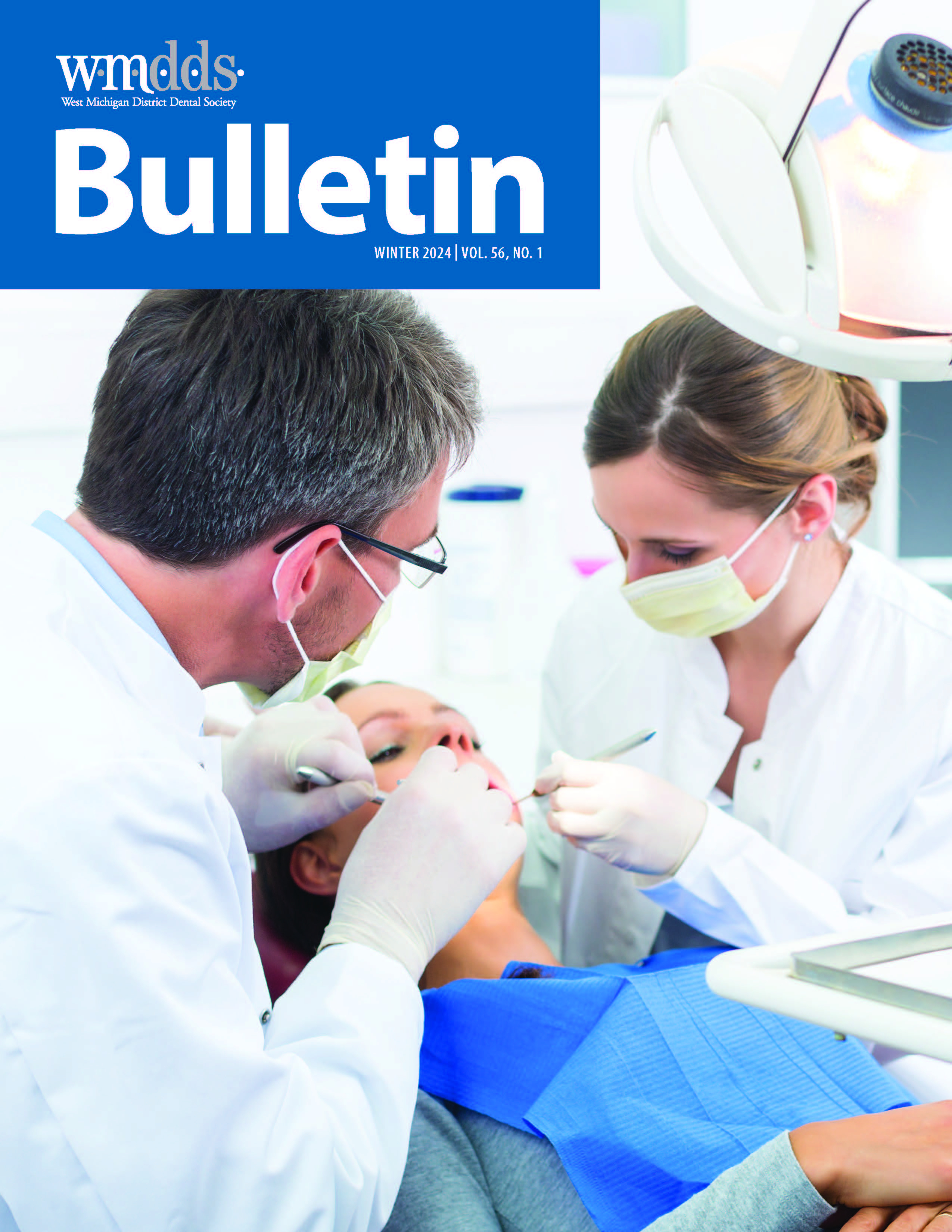 Cover of the WMDDS Bulletin with a photo two dentists working on the same patient.