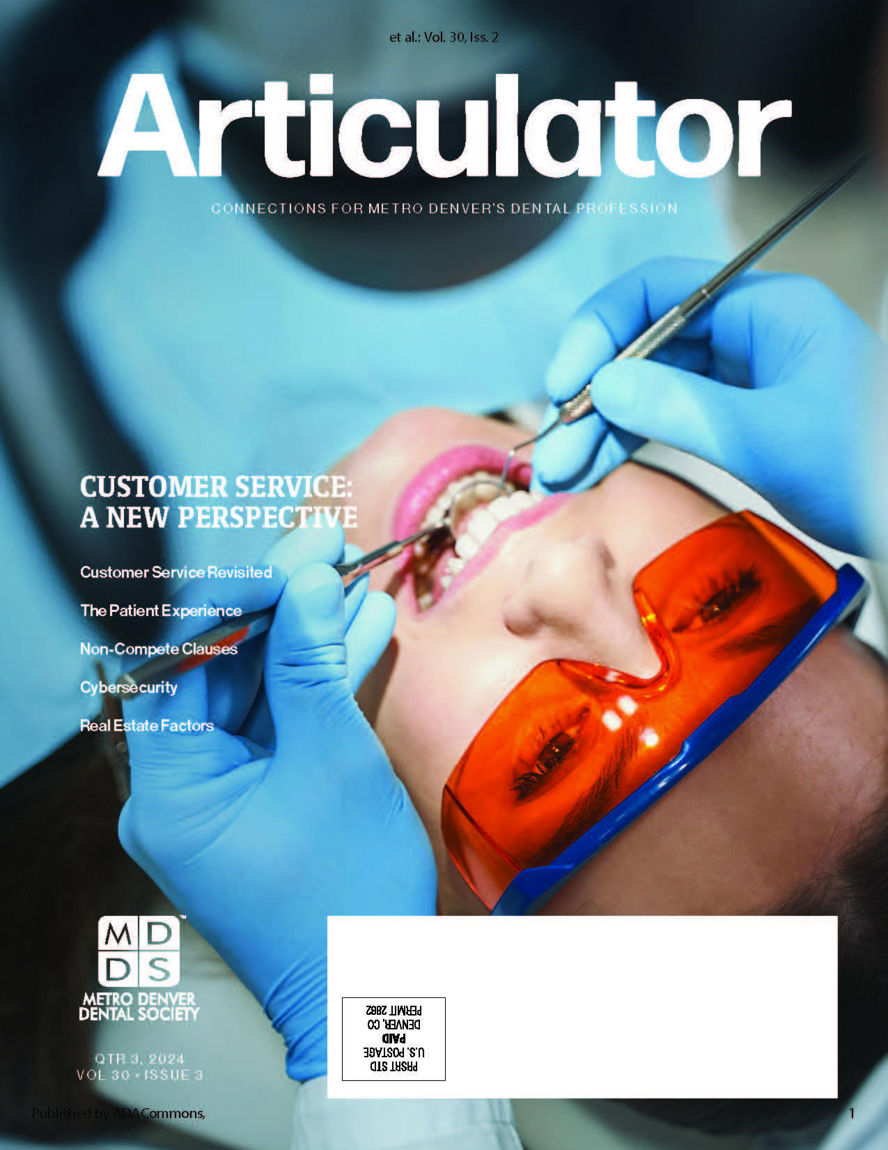 Cover of the MDDS Articulator featuring a close-up of a person receiving dental care's face. Gloved hands are visible.