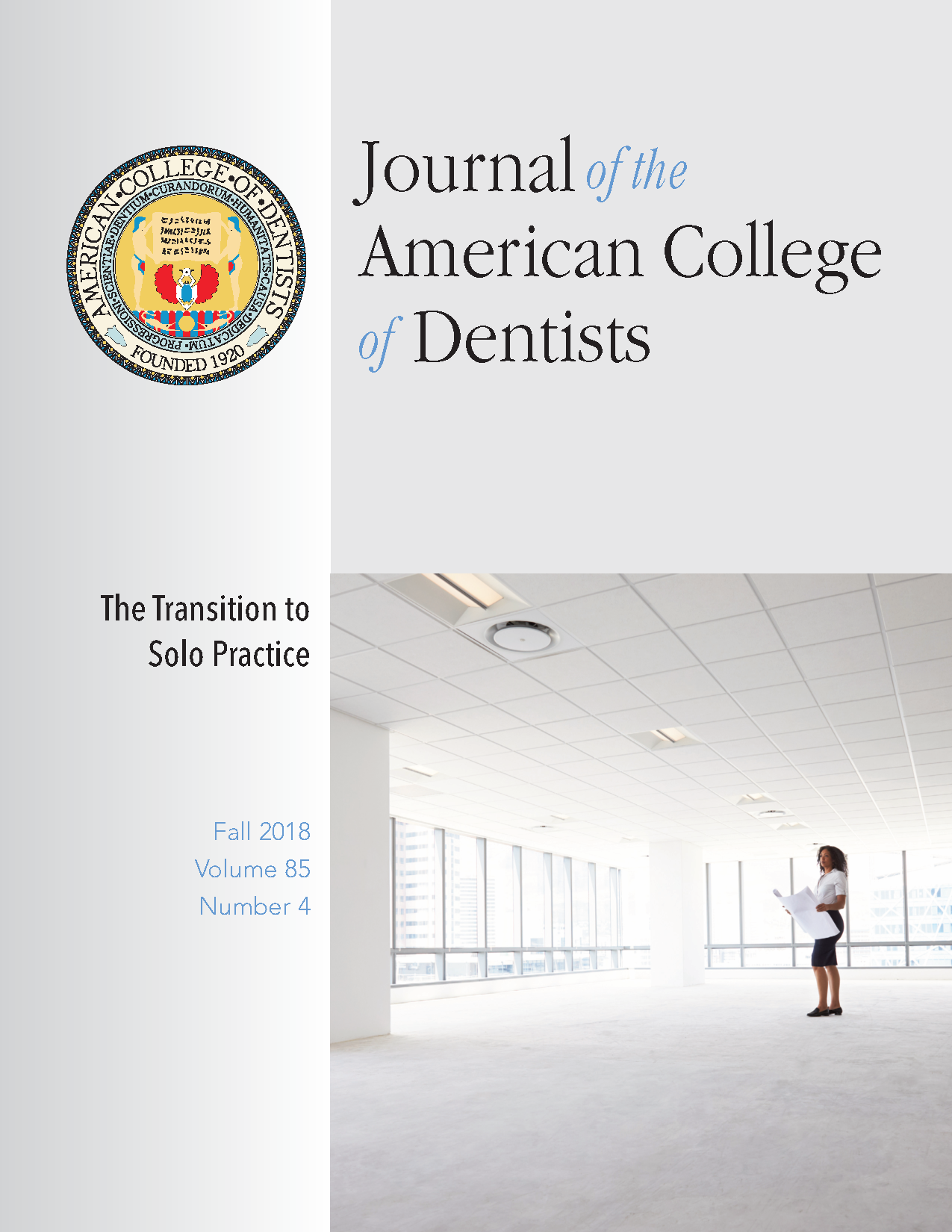 Photo of a young professional standing in an empty high rise office with blueprints