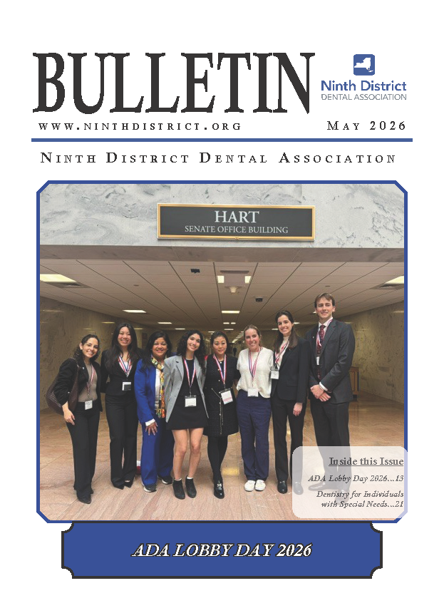 Photo of eight smiling young dental professionals posing at the Hart Senate Office Building during Lobby Day 2026