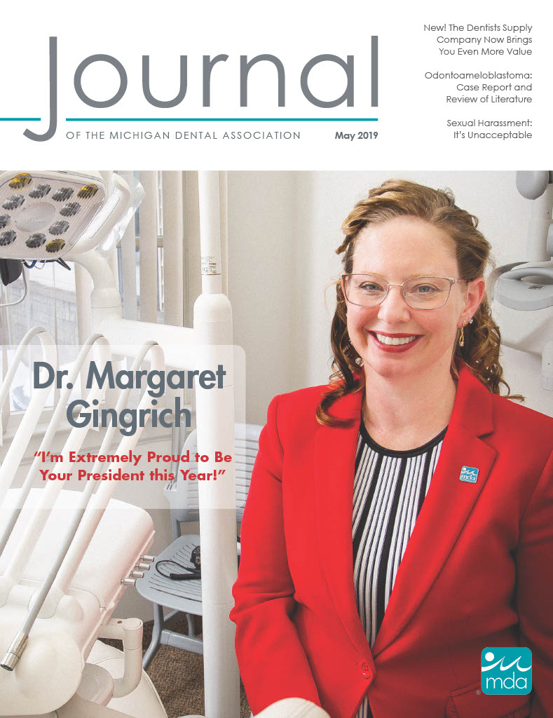 Cover of the Journal of the Michigan Dental Association featuring MDA President Dr. Margaret Gingrich in a dental office wearing a bright red blazer.