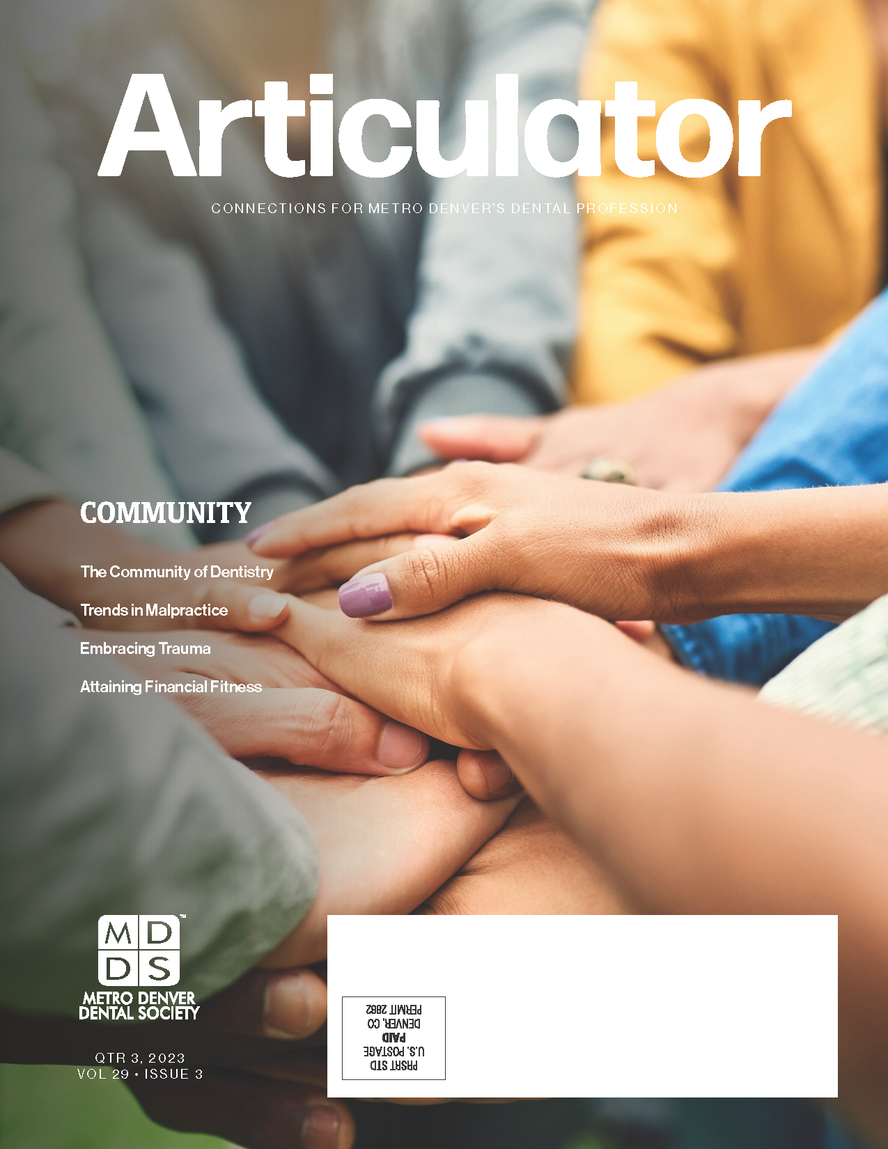 Cover of the Metro Denver Dental Society's Articulator magazine with image of many hands gathered together in the circle of a group of people to symbolize community.