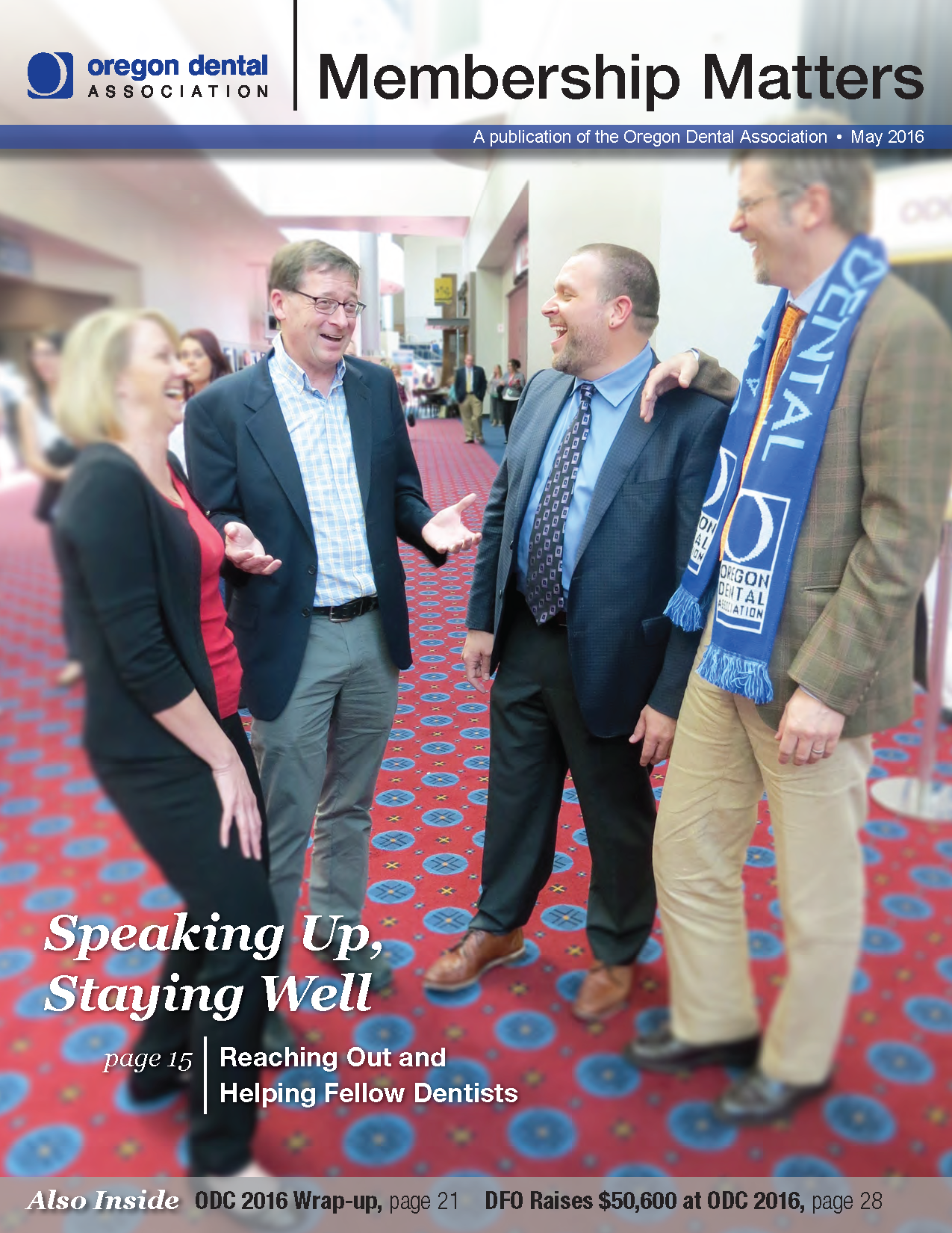 Photo of ODA Annual Meeting with four attendees gathered and laughing together